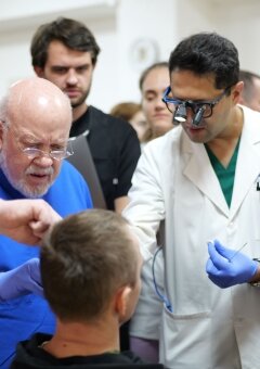 Dr. Ryan Winters, Dr. John Frodel, Dr. Parag Gandhi are examinating the patient at the 1st day of mission.